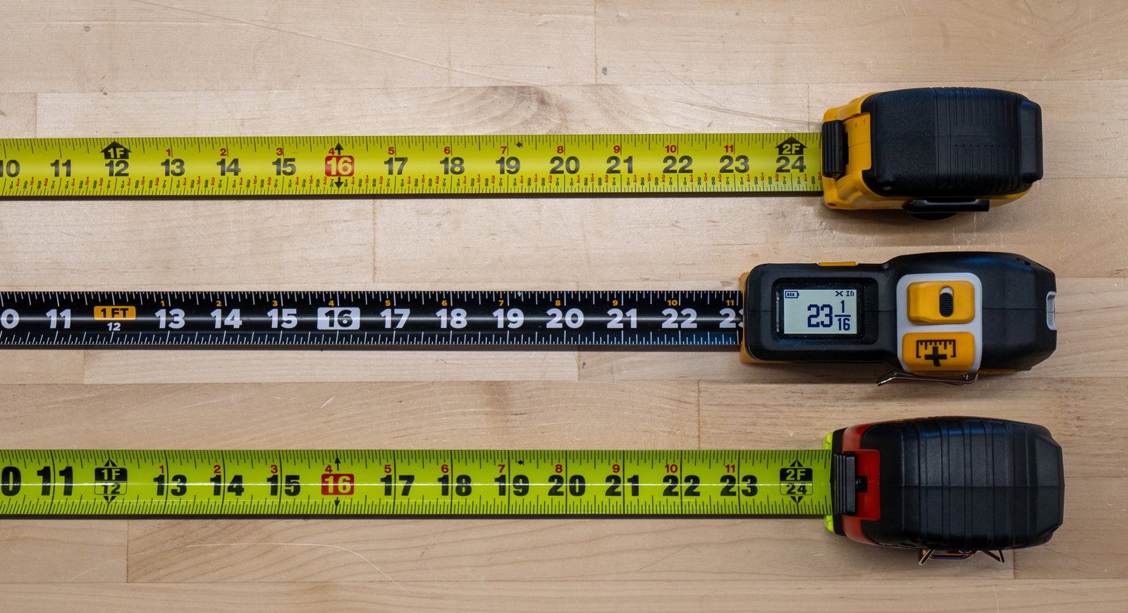 REEKON T1M digital tape measure between two conventional yellow tapes